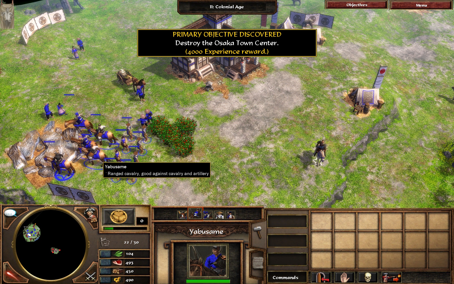 The Asian Dynasties campaign, Japan Act I, on macOS: Kichiro's army selected and moving by scripted input as the objective to destroy the Osaka Town Center appears.